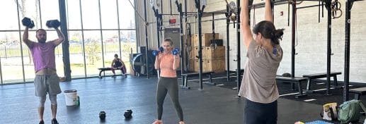 dual cities crossfit members lift weights